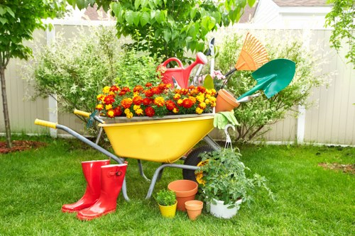 A gardener checking tools and site hazards before starting